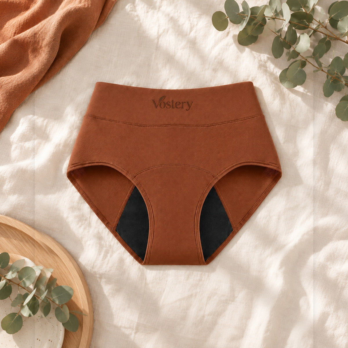 Culotte absorbante Vostery terracotta taille haute avec fond absorbant noir, posée à plat
