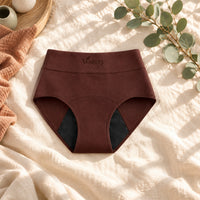 Culotte absorbante Vostery rouge lavé taille haute avec fond absorbant noir, posée à plat